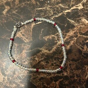 handmade white beaded bracelet with red accent beads